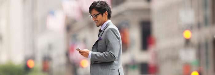 Business man looking at his mobile phone for business checking 