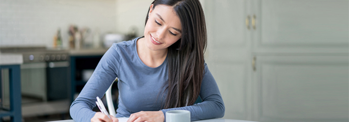 Smiling female writing